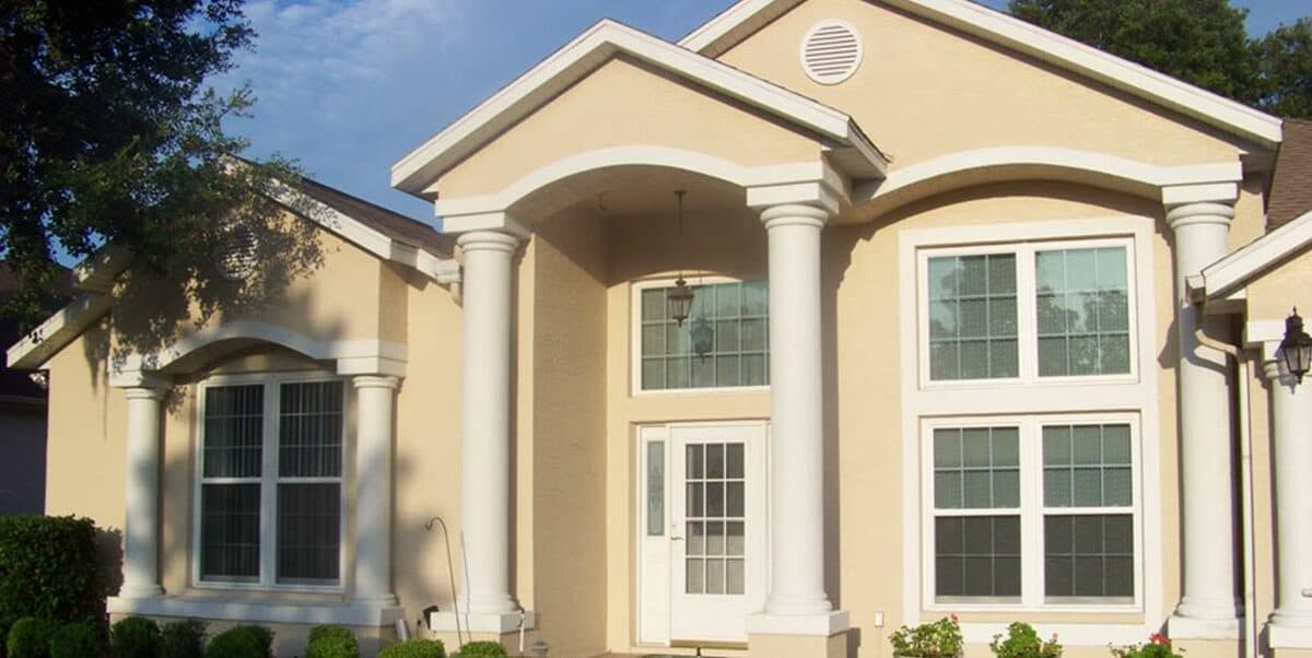 Two-story home with new windows and an arched entryway